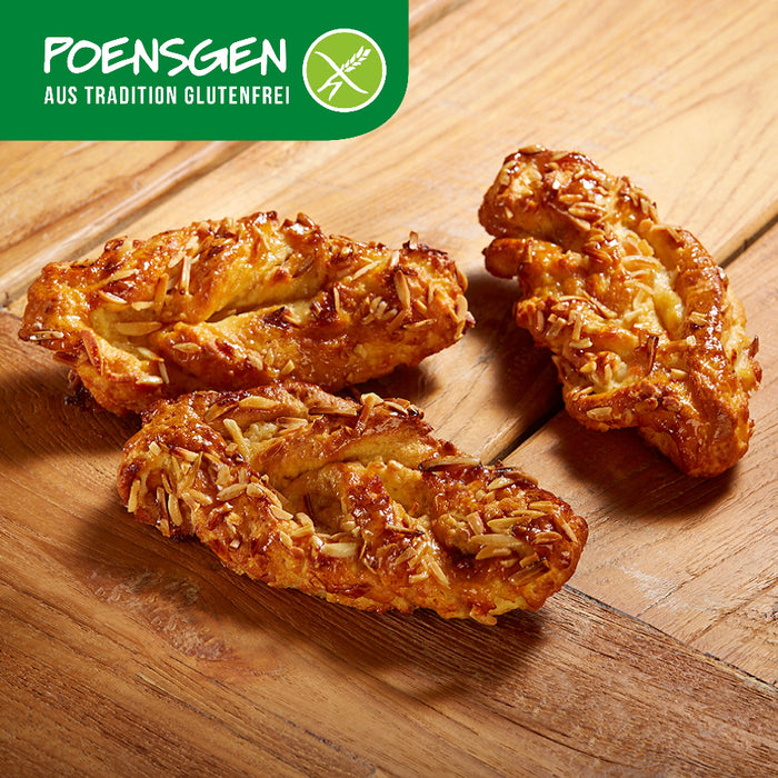 Mandel-Nuss-Plunder glutenfrei 2x110g - Poensgen

Unsere Mandel-Nuss-Plunder vereinen zarten Teig, aromatische Haselnüsse und Mandeln zu einem unwiderstehlichen Frühstücksgenuss. Ideal für alle, die auf Gluten und Laktose verzichten möchten, ohne auf Geschmack zu verzichten. Perfekt zum Kaffee oder Tee – für einen genussvollen Moment ganz ohne Kompromisse.